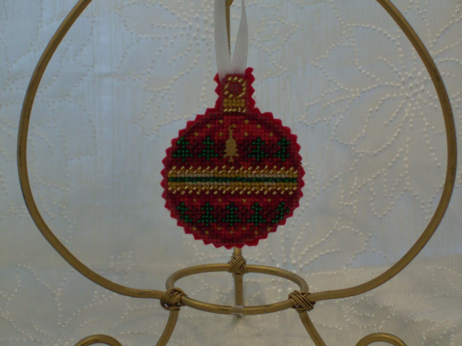 
Beaded cross-stitch ornament with tree charm